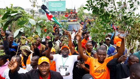 Mourners pictured surrounding a military vehicle carrying the body of former Kenyan Prime Minister Raila Odinga on Thursday.