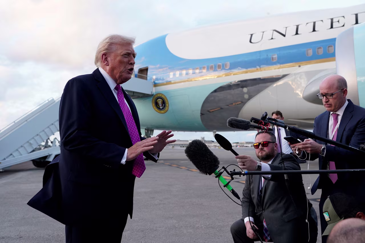 President Donald Trump speaks to members of the media as he arrives at Palm Beach International Airport, in West Palm Beach, Florida, on Friday.