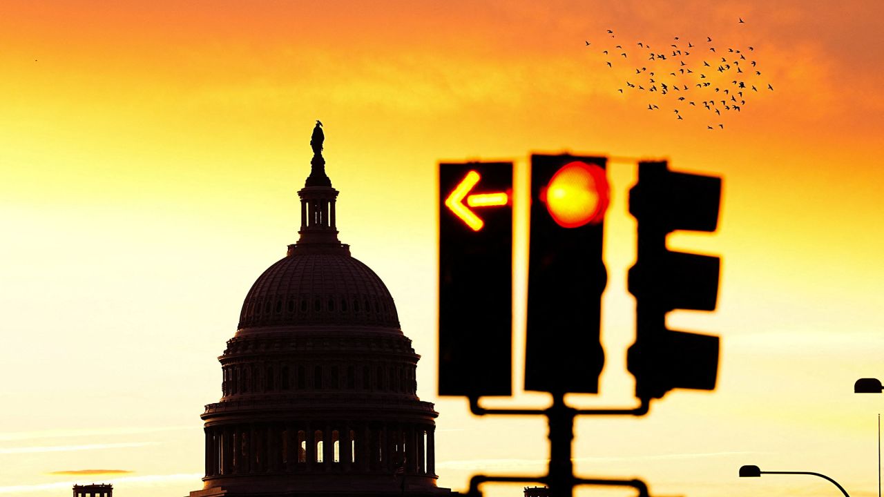 The sun rises behind the US Capitol on October 18.