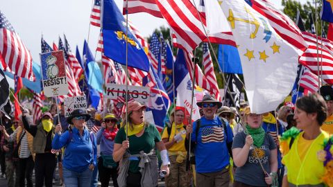 Demonstrators hold flags and placards during a "No Kings" protest against U.S. President Donald Trump's policies, in Washington, D.C., U.S., October 18, 2025.