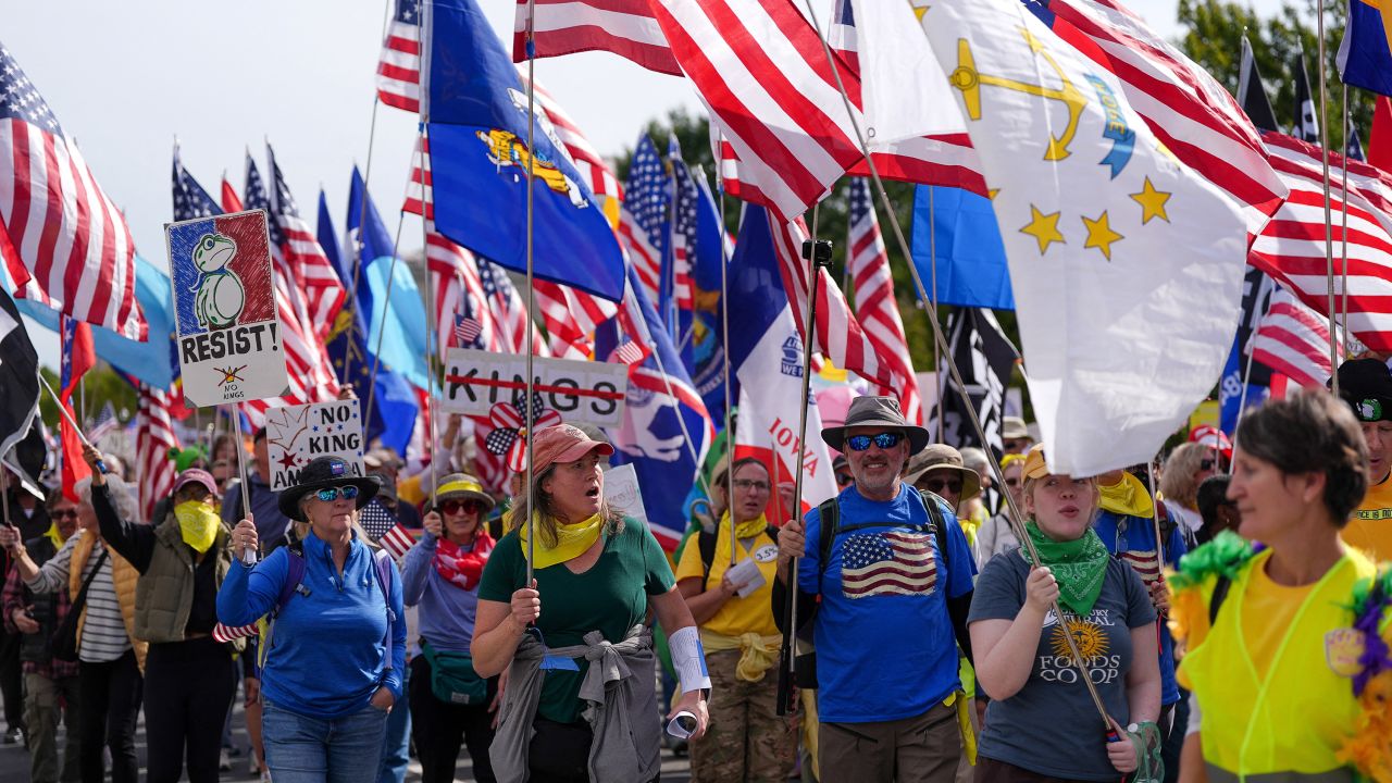 Demonstrators hold flags and placards during a "No Kings" protest against U.S. President Donald Trump's policies, in Washington, D.C., U.S., October 18, 2025.