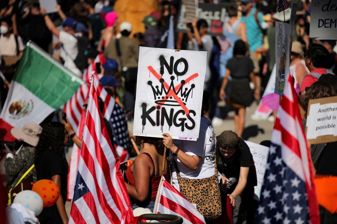 A protester holds a sign reading