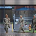 Members of the 49th Military Police Brigade from California, part of the Army National Guard military police brigade, walk across the ground at the Oregon Army National Guard's Camp Withycombe, as a divided U.S. appeals court ruled that U.S. President Donald Trump can send National Guard troops into Portland, in Happy Valley, Oregon, U.S., October 22, 2025.