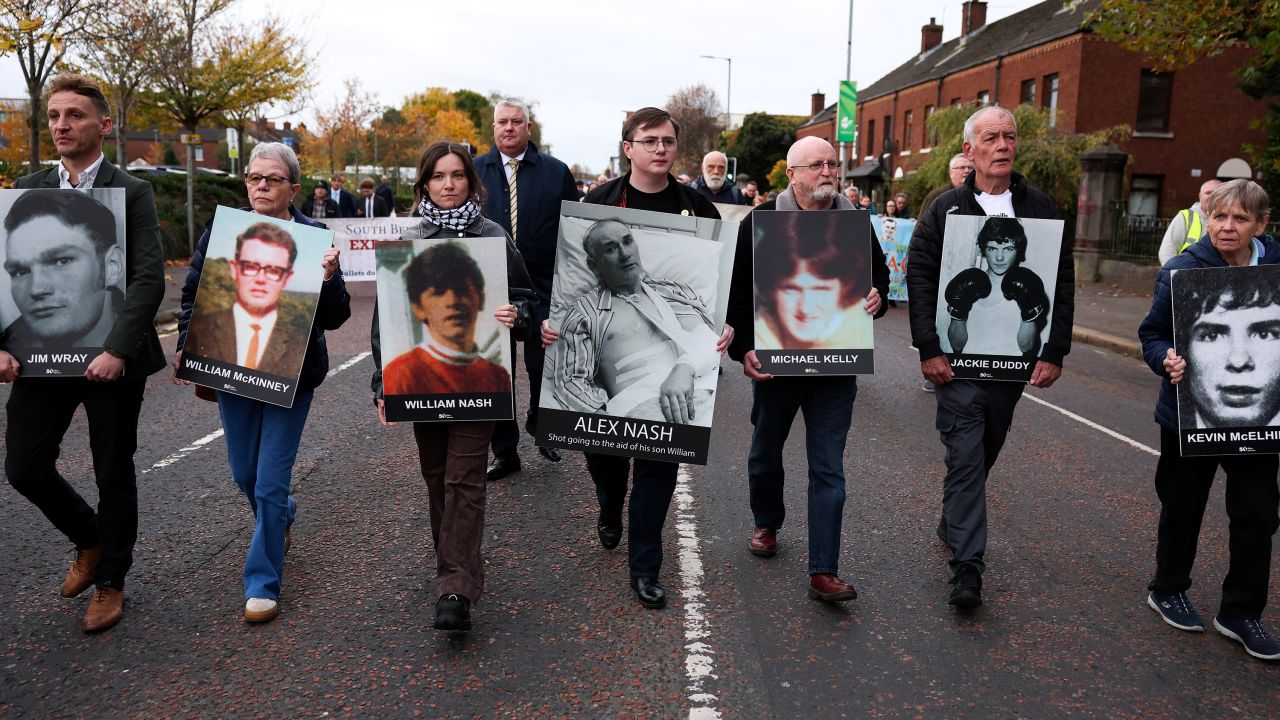 Family members hold pictures of victims of the 1972 'Bloody Sunday', as a judge is expected to give a verdict on the trial of the British army veteran known as 'Soldier F', charged with two murders and five attempted murders in relation to Bloody Sunday, in Belfast, Northern Ireland, October 23, 2025.