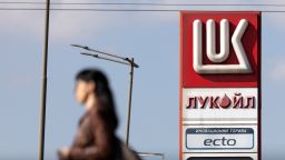 A woman walks near a Lukoil gas station in Sofia, Bulgaria, on October 23, 2025.