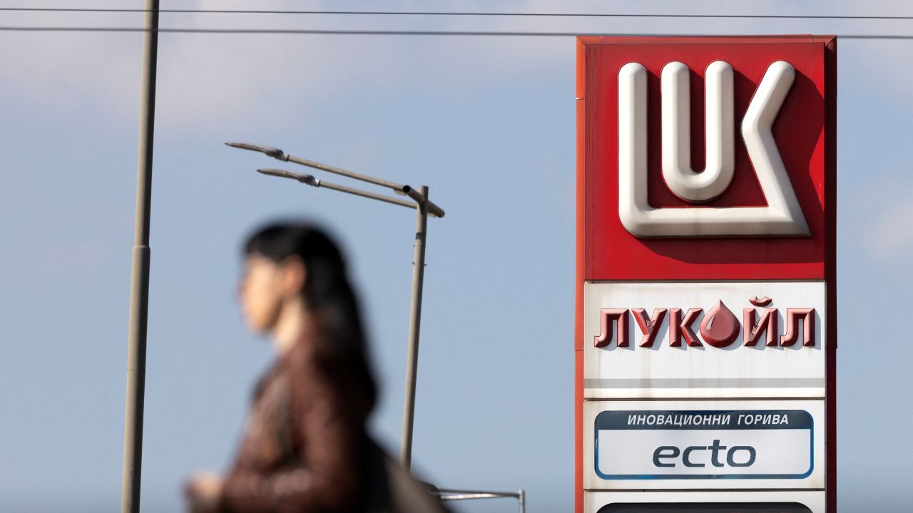 A woman walks near a Lukoil gas station in Sofia, Bulgaria, on October 23, 2025.