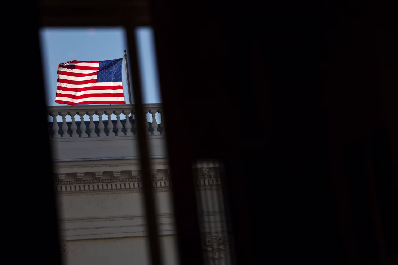 An American flag flutters outside the US Capitol on Thursday.