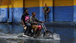 People transit on a motorcycle through a street flooded by rains caused by Tropical Storm Melissa, in Santo Domingo, Dominican Republic, October 23, 2025. REUTERS/Eddy Vittini