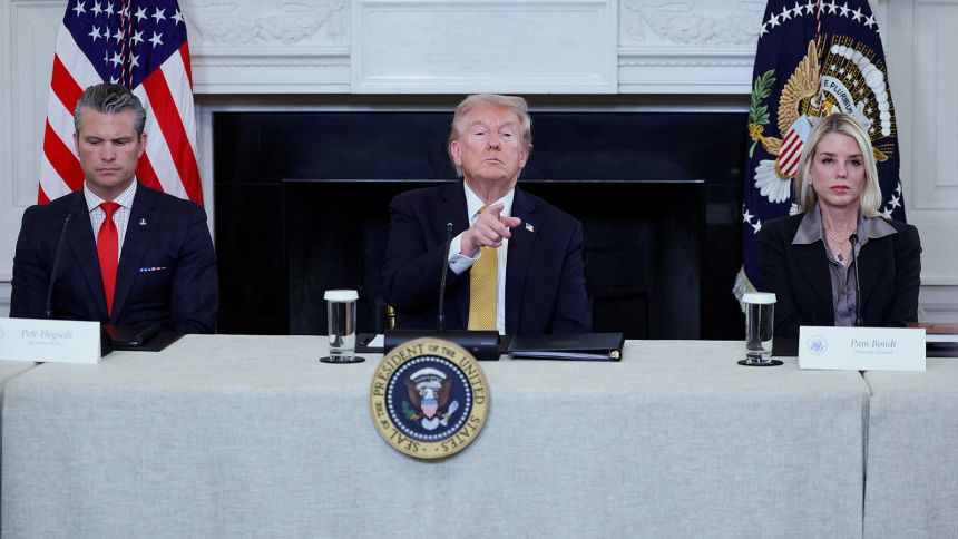 US. President Donald Trump gestures during an announcement regarding his administration's policies against cartels and human trafficking, next to Secretary of Defense Pete Hegseth and  Attorney General Pam Bondi, from the State Dining Room at the White House in Washington, DC, on Thursday.