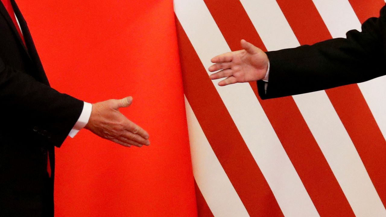 FILE PHOTO: U.S. President Donald Trump and China's President Xi Jinping shake hands after making joint statements at the Great Hall of the People in Beijing, China, November 9, 2017. Damir Sagolj: "It's one of those "how to make a better or at least different shot when two presidents shake hands several times a day, several days in row". If I'm not mistaken in calculation, presidents Xi Jinping of China and Donald Trump of the U.S. shook their hands at least six times in events I covered during Trump's recent visit to China. I would imagine there were some more handshakes I haven't seen but other photographers did. And they all look similar - two big men, smiling and heartily greeting each other until everyone gets their shot. But then there is always something that can make it special - in this case the background made of U.S. and Chinese flags. They shook hands twice in front of it, and the first time it didn't work for me. The second time I positioned myself lower and centrally, and used the longest lens I have to capture only hands reaching for a handshake." REUTERS/Damir Sagolj/File Photo  SEARCH "POY TRUMP" FOR THIS STORY. SEARCH "REUTERS POY" FOR ALL BEST OF 2017 PACKAGES.    TPX IMAGES OF THE DAY/File Photo