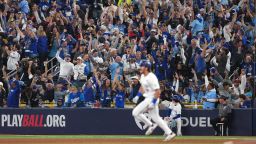 Fans celebrate as Toronto Blue Jays third baseman Addison Barger (47) runs after hitting a grand slam home run against the Los Angeles Dodgers in the sixth inning during game one of the 2025 MLB World Series at Rogers Centre on October 24, 2025.