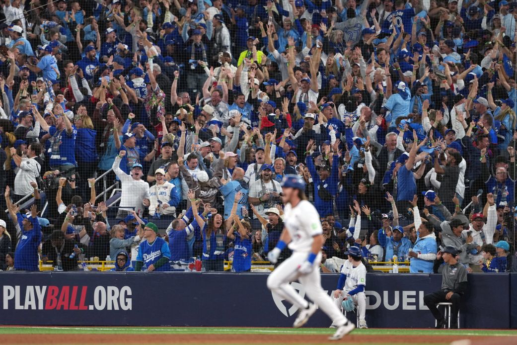 Fans celebrate after Toronto Blue Jays third baseman Addison Barger hits a grand slam home run against the Los Angeles Dodgers in the sixth inning during Game 1 of the World Series.