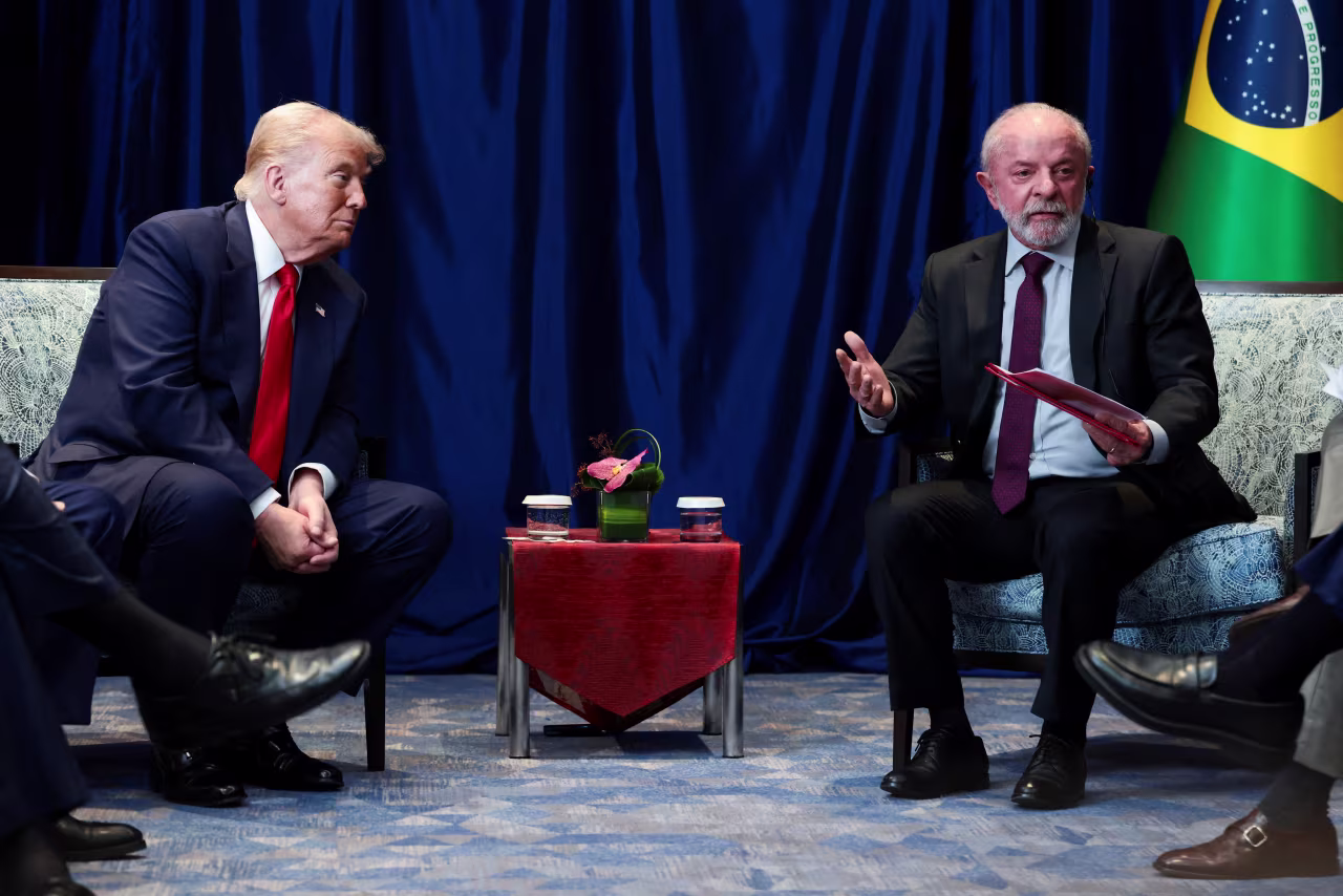 US President Donald Trump listens to Brazilian President Luiz Inacio Lula da Silva speak as they meet at the ASEAN summit in Kuala Lumpur on Sunday.