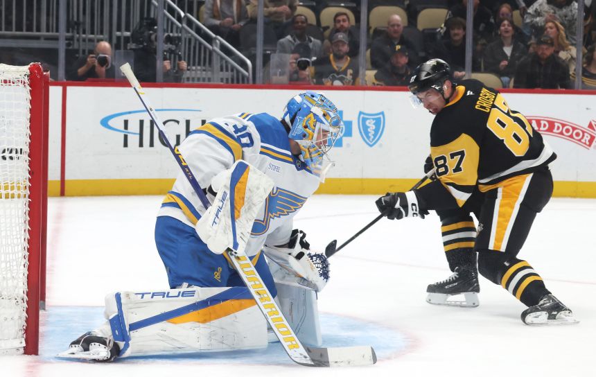 Pittsburgh Penguins center Sidney Crosby scores a goal against the St. Louis Blues during the third period in Pittsburgh.