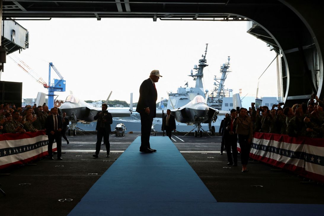 President Donald Trump looks on toward US Navy sailors aboard the aircraft carrier USS George Washington, in Yokosuka, on Tuesday.
