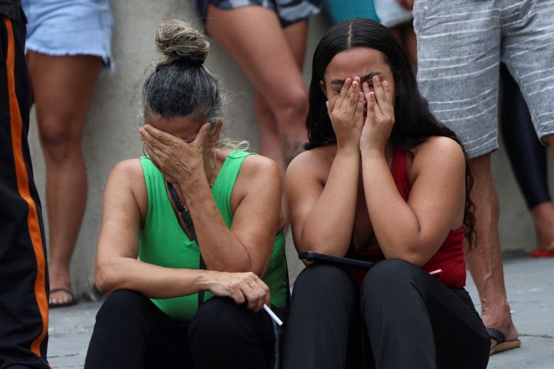 People react while waiting for news outside a hospital on the day of a police operation against drug trafficking in Rio de Janeiro, Brazil, on Tuesday.