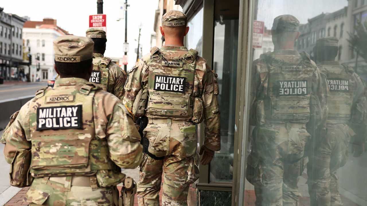 Military police patrol a shopping street in the Georgetown neighborhood of Washington, DC, on October 29, 2025.