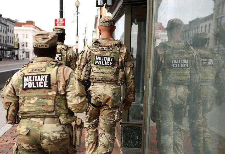 Military police patrol a shopping street in the Georgetown neighborhood of Washington, DC, on October 29, 2025.