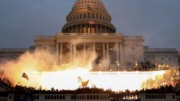 An explosion caused by a police munition is seen while supporters of President Donald Trump riot in front of the US Capitol on January 6, 2021.