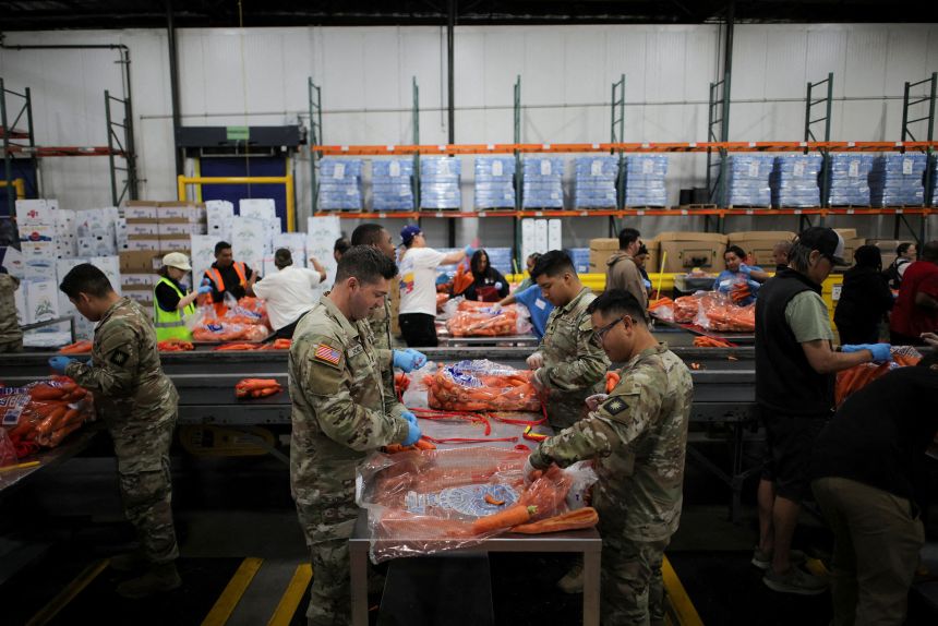Members of the National Guard pack food at a Los Angeles Regional Food Bank facility in Los Angeles, California, on October 29, 2025.