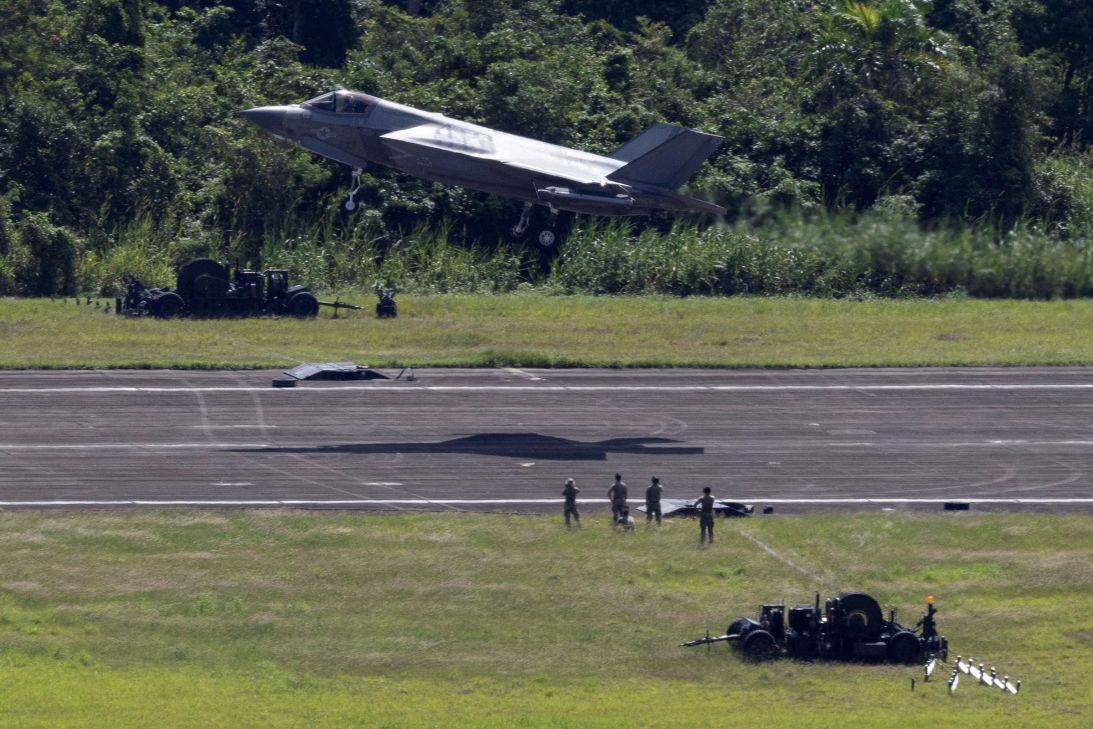 A US Marine Corps F-35B lands as military personnel work at the former Roosevelt Roads Naval Station airport in Ceiba, Puerto Rico, on November 4, amid a buildup of US military assets in the Caribbean.