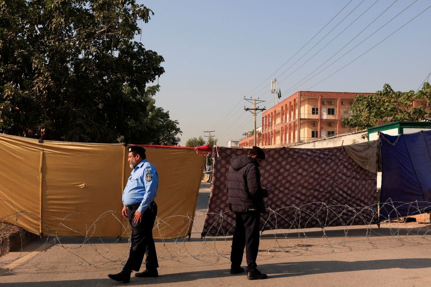 Police officers stand on a cordoned road, a day after a blast outside the district court building, in Islamabad, Pakistan, November 12, 2025.