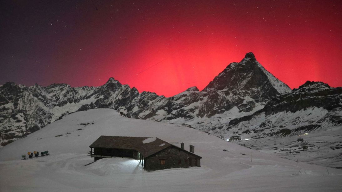 The reddish hue of the northern lights can be seen over the town of Valtournenche, located in Italy's Aosta Valley, on Wednesday, November 12.