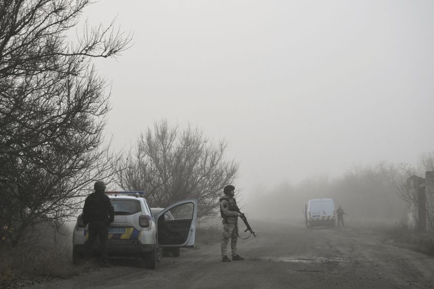 A Ukrainian police officer inspects an area during the evacuation of civilians from the frontline town of Khlyaipol in Ukraine's Zaporizhzhya region, November 14, 2025.