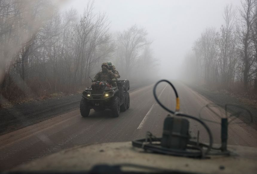 Ukrainian servicemen ride a military buggy along a road near the frontline town of Pokrovsk in the Donetsk region, on November 23.