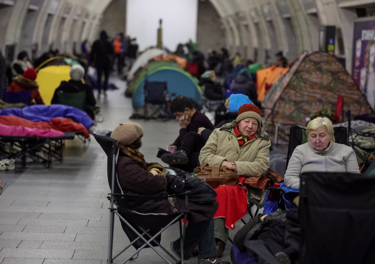 People take shelter inside a metro station in Kyiv during a Russian missile and drone strike on Tuesday.