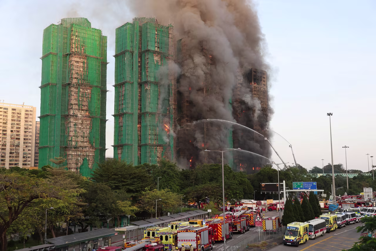 Efforts are underway to extinguish flames engulfing bamboo scaffolding across multiple buildings at the Wang Fuk Court housing estate in Hong Kong on November 26.