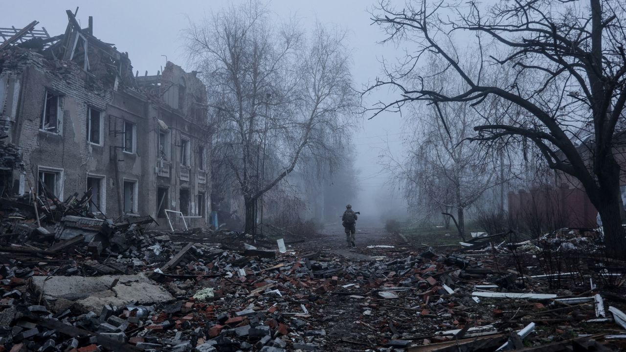 A Ukrainian serviceman walks near apartment buildings damaged by Russian military strike, amid Russia's attack on Ukraine, in the frontline town of Kostiantynivka in Donetsk region, Ukraine November 28, 2025.