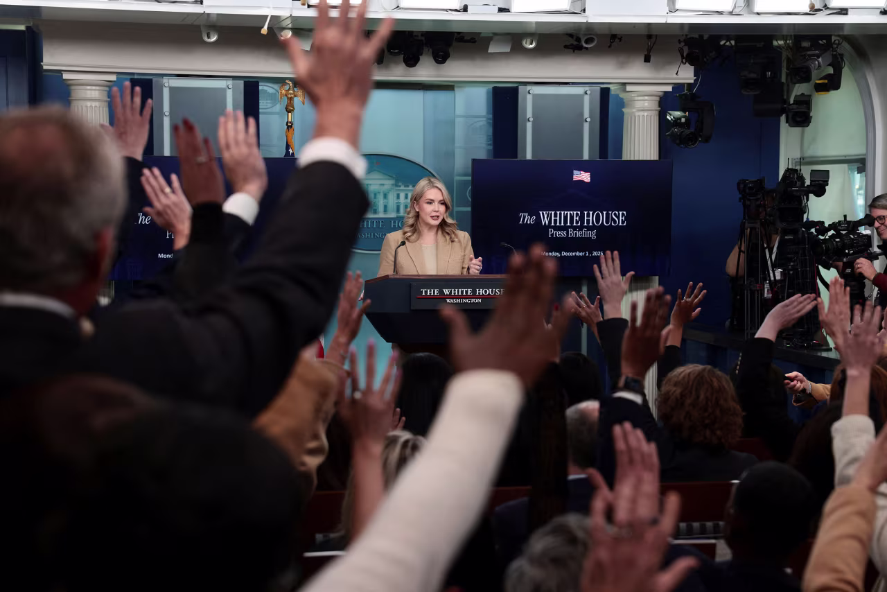 Hands are raised as White House Press Secretary Karoline Leavitt holds a press briefing at the White House, on Monday.