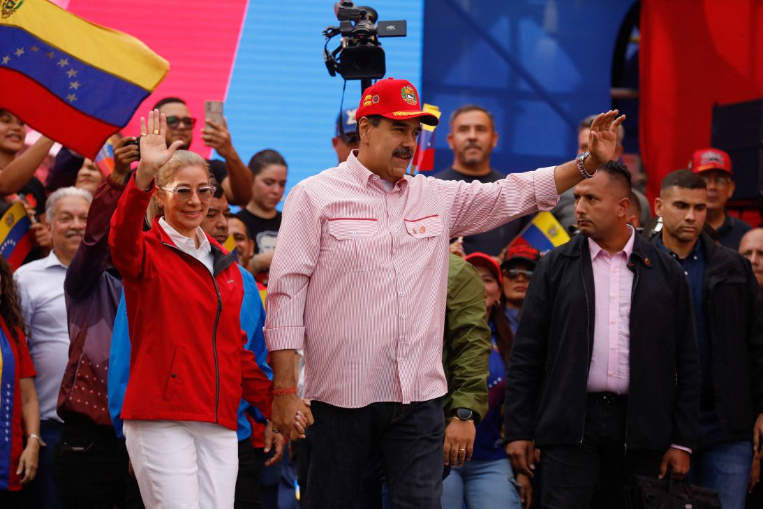 Venezuelan President Nicolás Maduro shakes while holding the hand of his wife, Cilia Flores, during a ceremony in Caracas, Venezuela, on Monday.