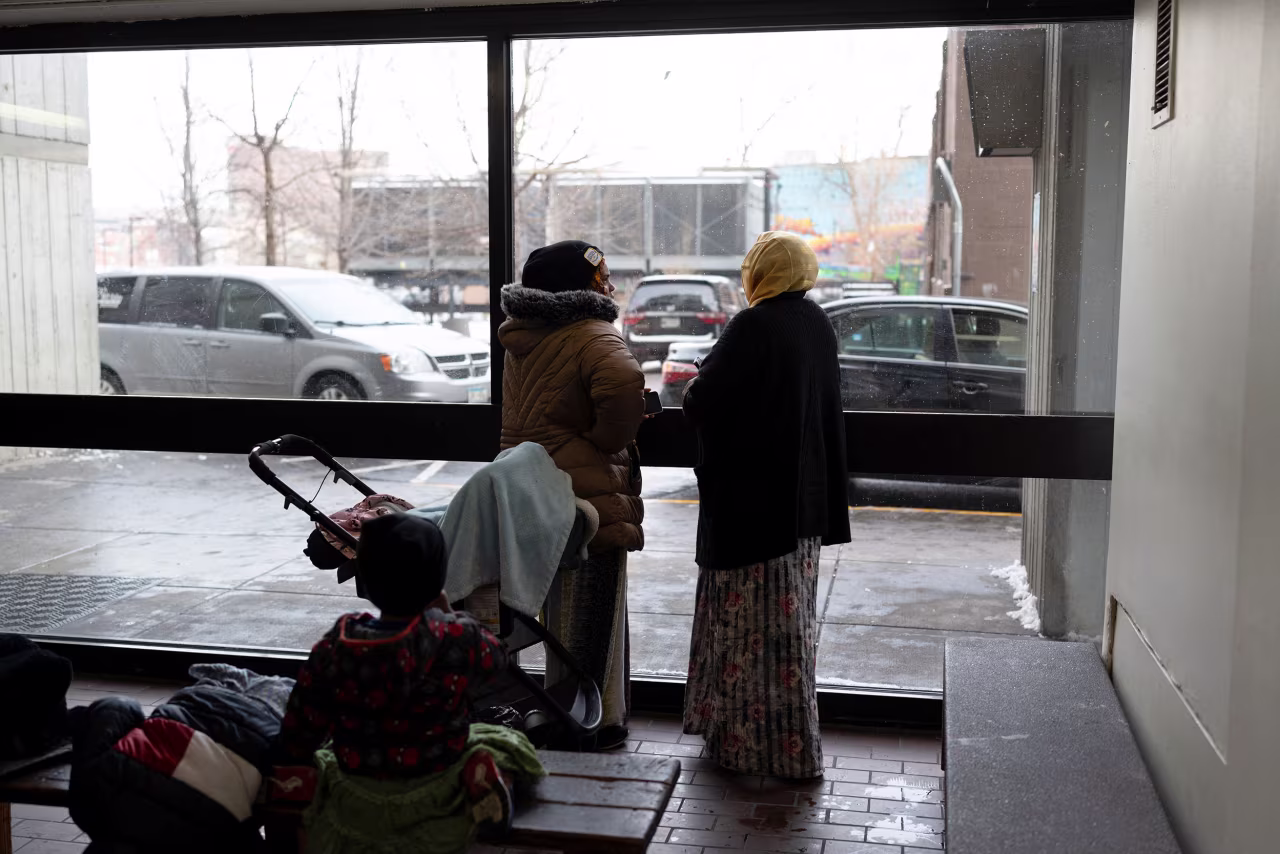 Somali residents look out of the lobby of an apartment complex popular among Somali-Americans in Minneapolis, Minnesota, on December 2.