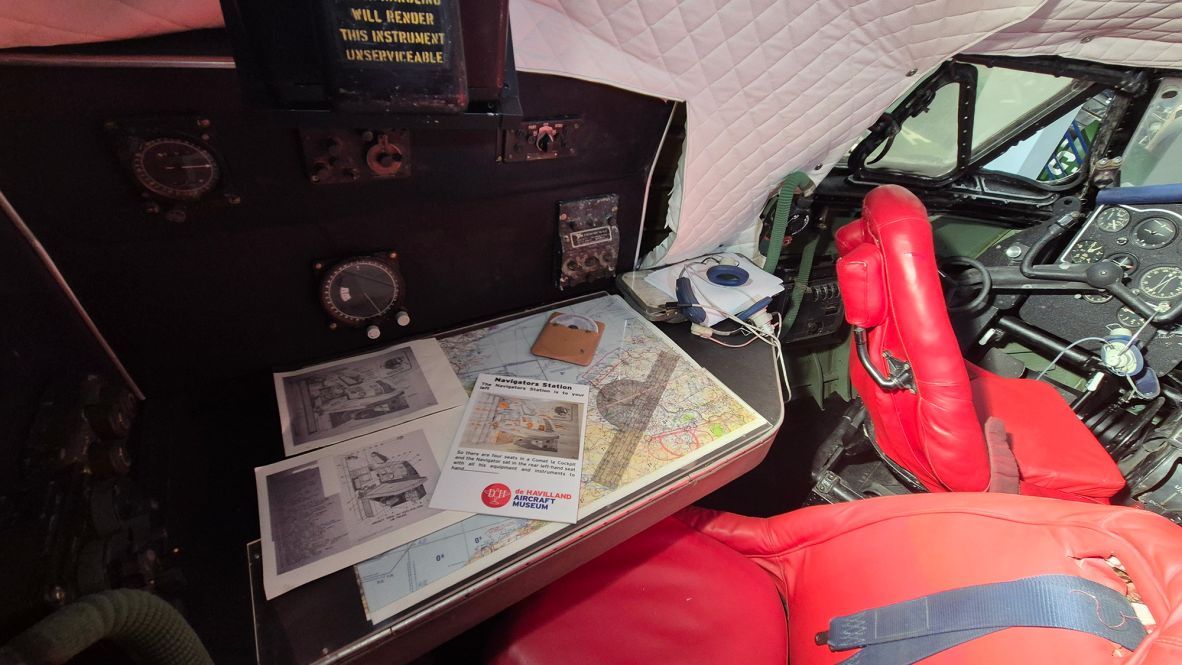 <strong>Maps and mathematics:</strong> The cockpit also included a table for the navigator, who would manually calculate position based on speed and direction. An astrolabe was fitted in the ceiling of the plane so that the navigator could also take position readings using the stars.