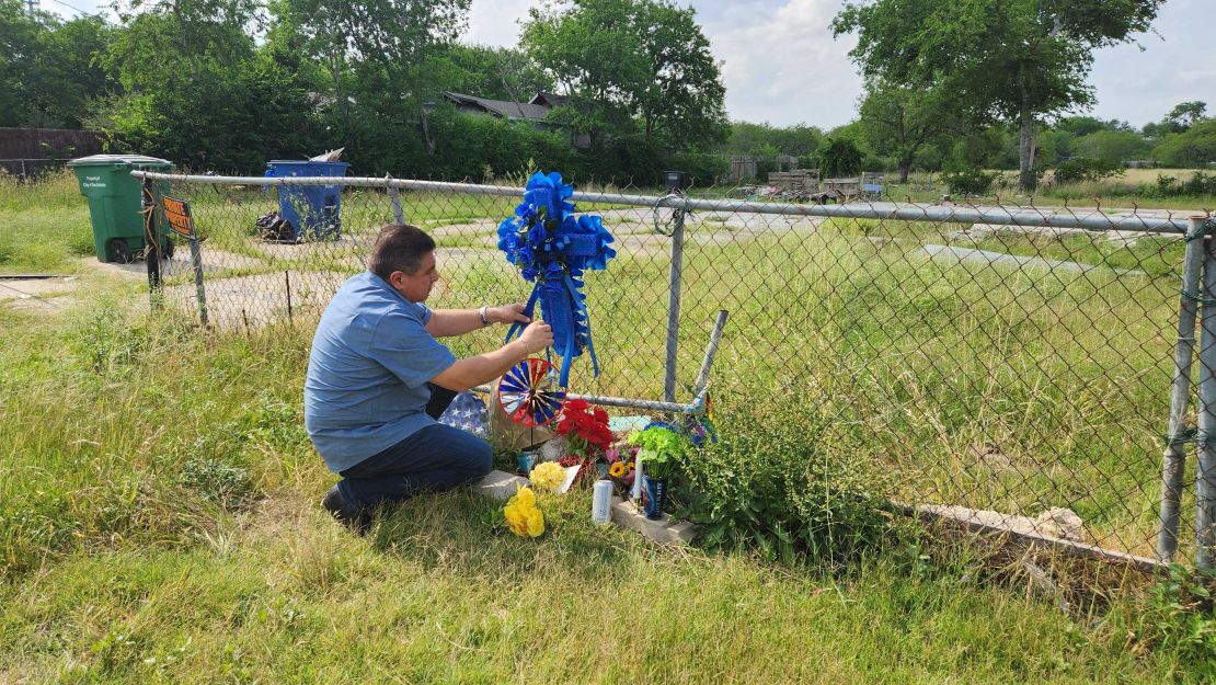 Adrian Reyes puts cross on the site of Joss' former home.