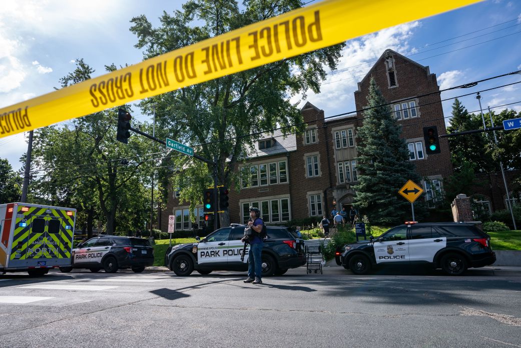 Police and emergency response vehicles line the street at Annunciation Catholic Church and School on Wednesday.