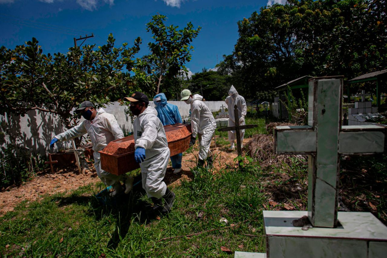 Cemetery workers carry a coffin at the municipal cemetery Recanto da Paz in Breves, Brazil, on June 7.