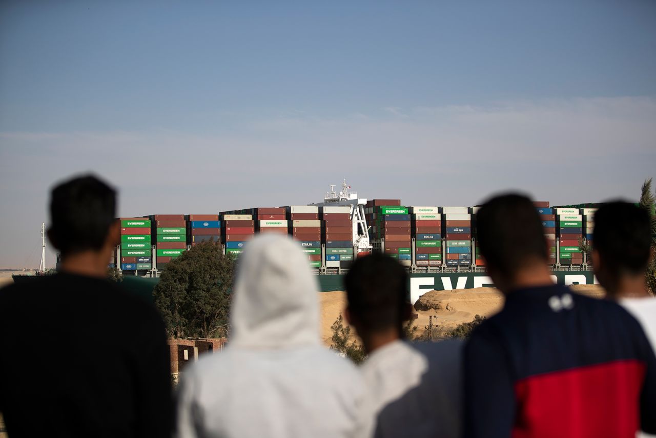 People watch as the container ship 'Ever Given' is refloated, unblocking the Suez Canal in Egypt, on March 29.