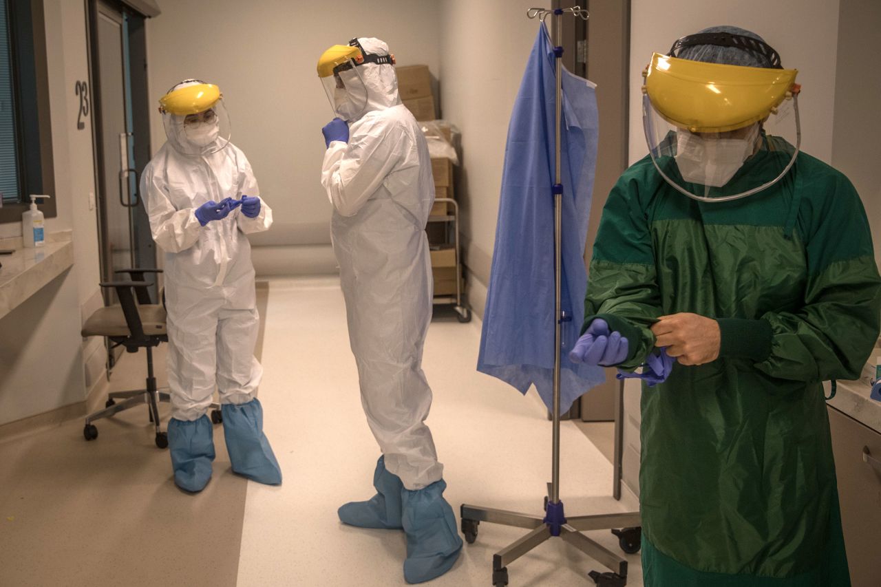 An assistant doctor and nurses prepare to perform a procedure on a patient infected with Covid-19 at the  Acibadem Altunizade Hospital on April 20, in Istanbul, Turkey.