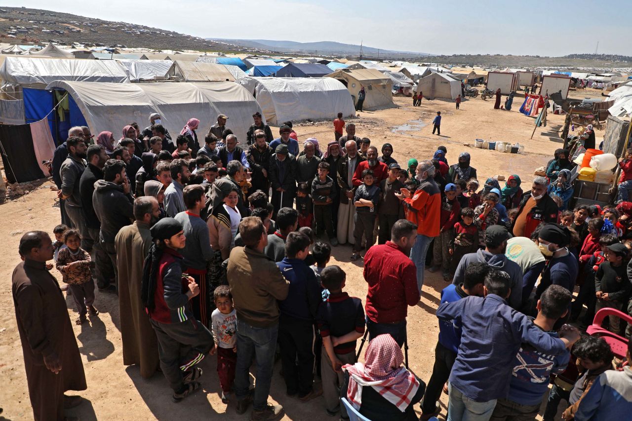 Medical staff from a Turkish humanitarian group give a lecture to raise awareness about the coronavirus epidemic at a camp for displaced Syrians in Kafr Lusin, on the border with Turkey, in Syria's northwestern province of Idlib, on March 23.