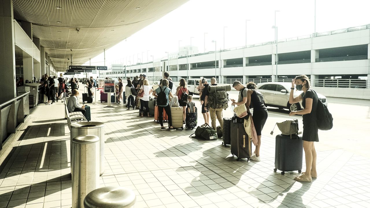 Travelers arrive at the Detroit Metropolitan Wayne County Airport in Romulus, Michigan, on Saturday, June 12.