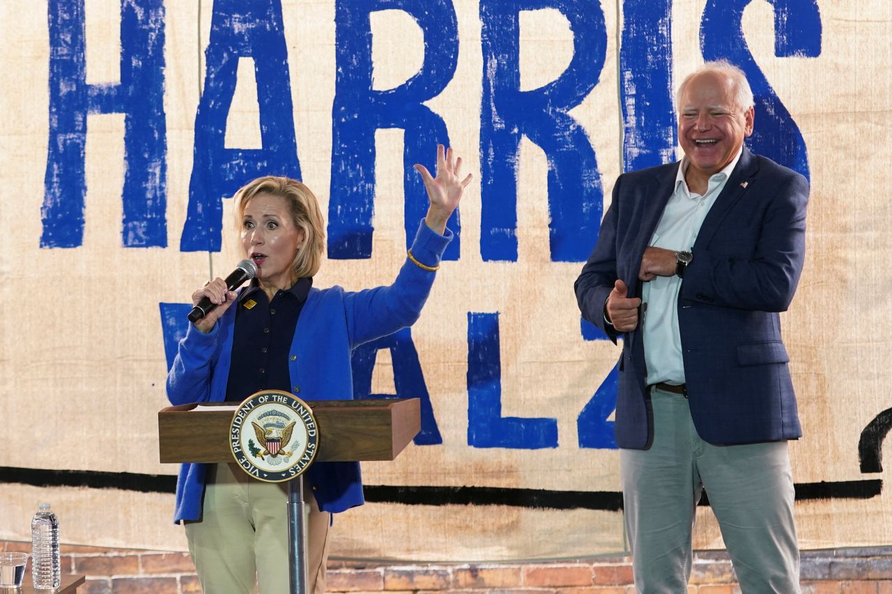 Gwen Walz, wife of US Democratic vice presidential candidate Minnesota Gov. Tim Walz, speaks next to her husband at a campaign field office in Rochester, Pennsylvania, on August 18.