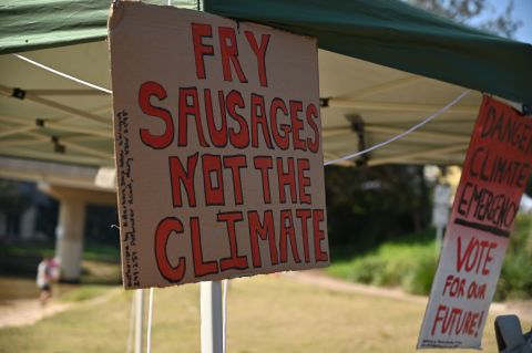 Climate change activists calling for action on global warming outside a polling station in the Liberal-held Sydney seat of Warringah on May 18, 20.