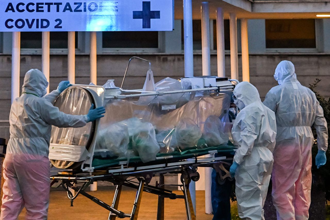 A patient in a biocontainment unit is carried on a stretcher at the Columbus Covid 2 Hospital in Rome, Monday, March 16.