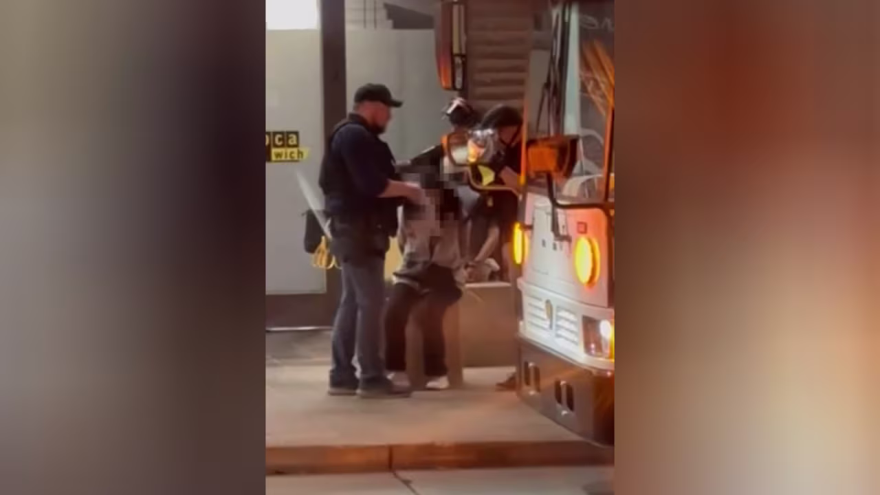 This screengrab shows a campus police officer removing a hijab off a protester’s head at Arizona State University, Phoenix, Arizona.