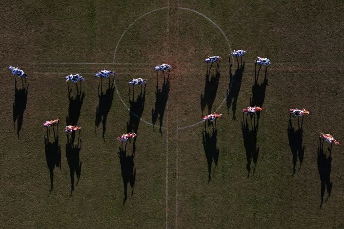 People dressed as Moorish and Christian knights ride horses during a battle reenactment during the Cavalhadas festival in Pirenópolis, Brazil, on Monday, June 9.
