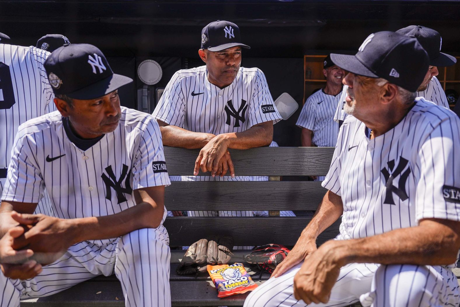 Ramiro Mendoza, Mariano Rivera and Luis Sojo talk in the dug out ahead of the <a href="index.php?page=&url=https%3A%2F%2Fwww.cnn.com%2F2025%2F08%2F09%2Fsport%2Fmariano-rivera-achilles-yankees-old-timers-day-spt">Yankees Old-Timers' Day ceremony</a> before a baseball game in New York against the Houston Astros on Saturday, August 9. The Yankees restored the Old-Timers’ Day game for the first time since 2019.