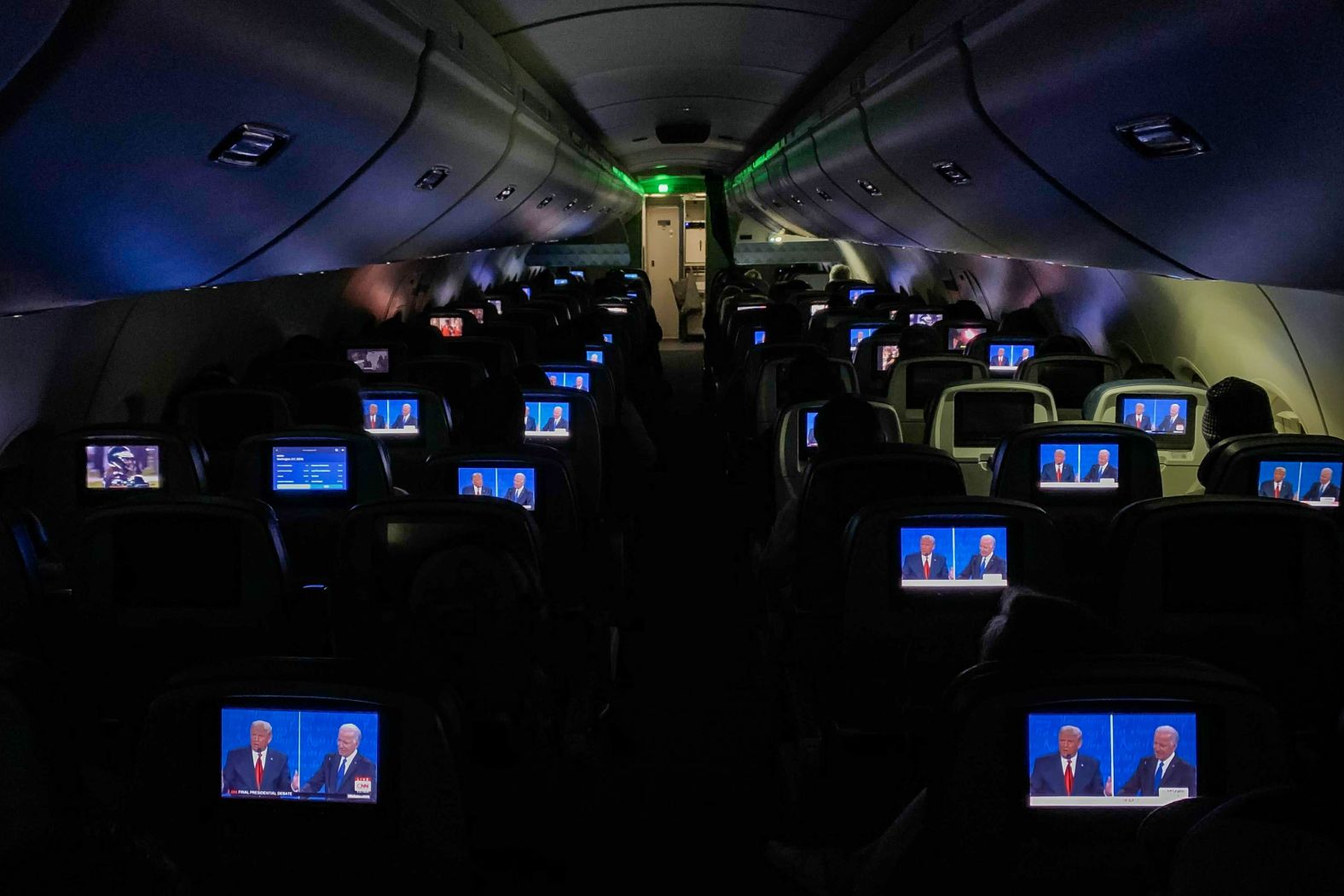 The final presidential debate between Joe Biden and President Donald Trump appears on screens during a flight from Detroit in 2020.